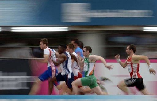 France's Christophe Lemaitre (L) leads the men's 100m qualifications